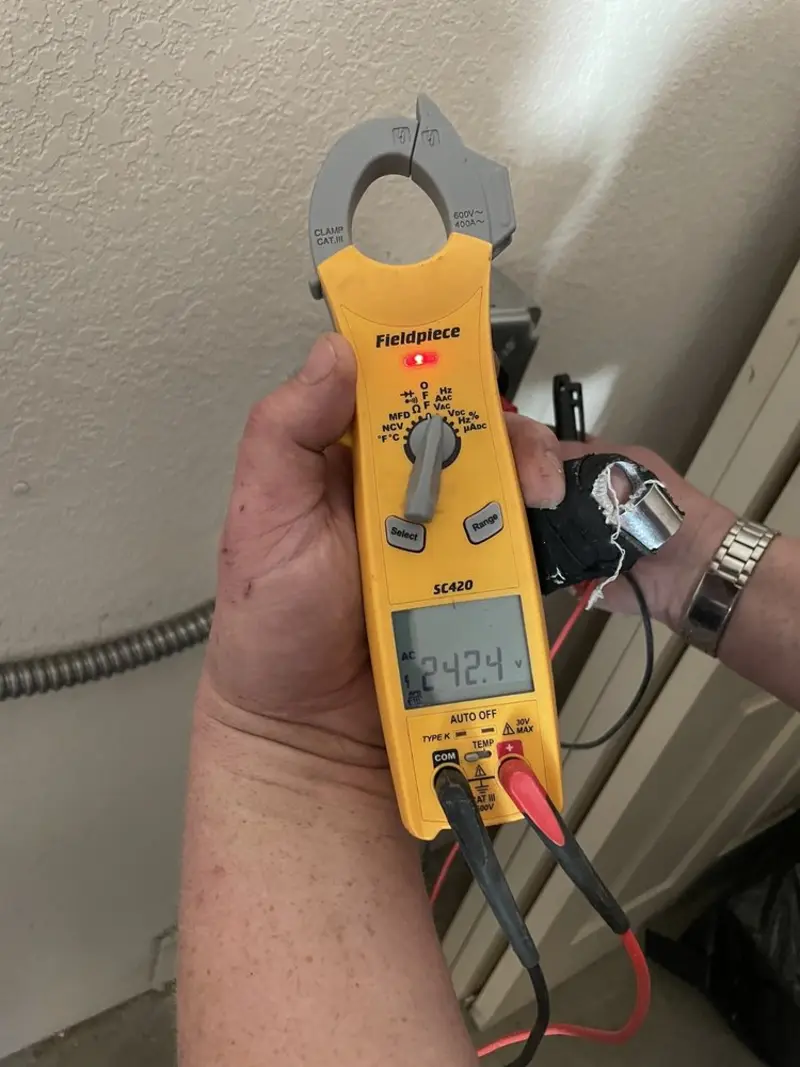 Voltage testing with clamp meter during Ceiling Fan Installation in Lakewood